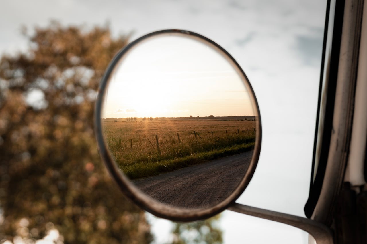 Home A serene countryside landscape reflected in a car